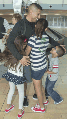 SAN DIEGO (April 16, 2017) Chief Gunners Mate John Mendoza, assigned to Littoral Combat Ship (LCS) Crew 204, embraces his children during a homecoming celebration at San Diego International Airport. LCS Crew 204 deployed in June 2016 aboard USS Coronado (LCS 4) for the ship's maiden overseas deployment in support of operations with regional navies in the 7th Fleet Area of Responsibility. U.S. Navy photo by MC2 Zachary Bell