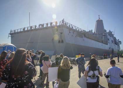 SAN DIEGO (Jan 22, 2018) Local media and families gather on the pier as the future San Antonio-class amphibious transport dock ship USS Portland (LPD 27) arrives into its new homeport of San Diego. Portland, named after the largest city in Oregon, is the 11th San Antonio-class amphibious transport dock ship and is the third ship to bear the name USS Portland. The ship is scheduled to be ceremoniously commissioned Apr. 21 in Portland, Ore. U.S. Navy Photo by MC2 Jesse Monford