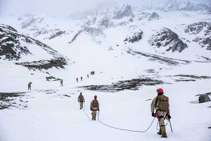 Snowy Climb: Marine Corps Mountain Warfare Training Center instructors hike alongside Argentine marines to the summit of a mountain range at Martial Glacier in Ushuaia, Argentina, Sept. 6, 2024. The hike fosters camaraderie and mutual reliance between U.S. and Argentine forces, which aims to strengthen their ability to work together for future exercises. USMC photo by Marine Corps Cpl. Samuel Qin 