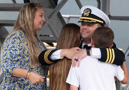 Cmdr. Michael McInerney, from Virginia Beach, Va., commanding officer of the Arleigh Burke-class guided-missile destroyer USS Russell (DDG 59) reunites with his family during the ship’s homecoming ceremony at Naval Base San Diego, Oct. 15, 2024, following an eight-month deployment. The Russell departed San Diego on Feb. 10, and joined the Theodore Roosevelt Carrier Strike Group in the U.S. 3rd, 5th, and 7th Fleet areas of operation to conduct global maritime security operations supporting regional stability. U.S. Navy photo by MC2 Maria G. Llanos