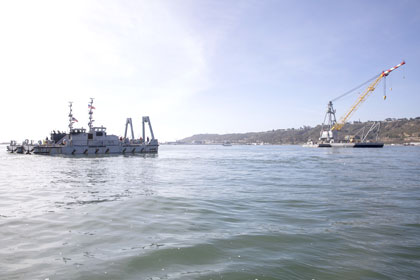 SAN DIEGO BAY (Feb 15, 2024) Warping tugs assigned to Amphibious Construction Battalion (ACB) 1 guide a YD-254 Crane to the salvage site for an EA-18G Growler in San Diego Bay, Feb. 15, 2025. U.S. Navy Sailors are actively working with partners during the salvage for an EA-18G Growler; a temporary safety zone for navigable waters in the vicinity of Naval Base Point Loma and Shelter Island in San Diego Bay has been established and environmental protection measures are in place. U.S. Navy photo by MC1 Jerome Johnson.